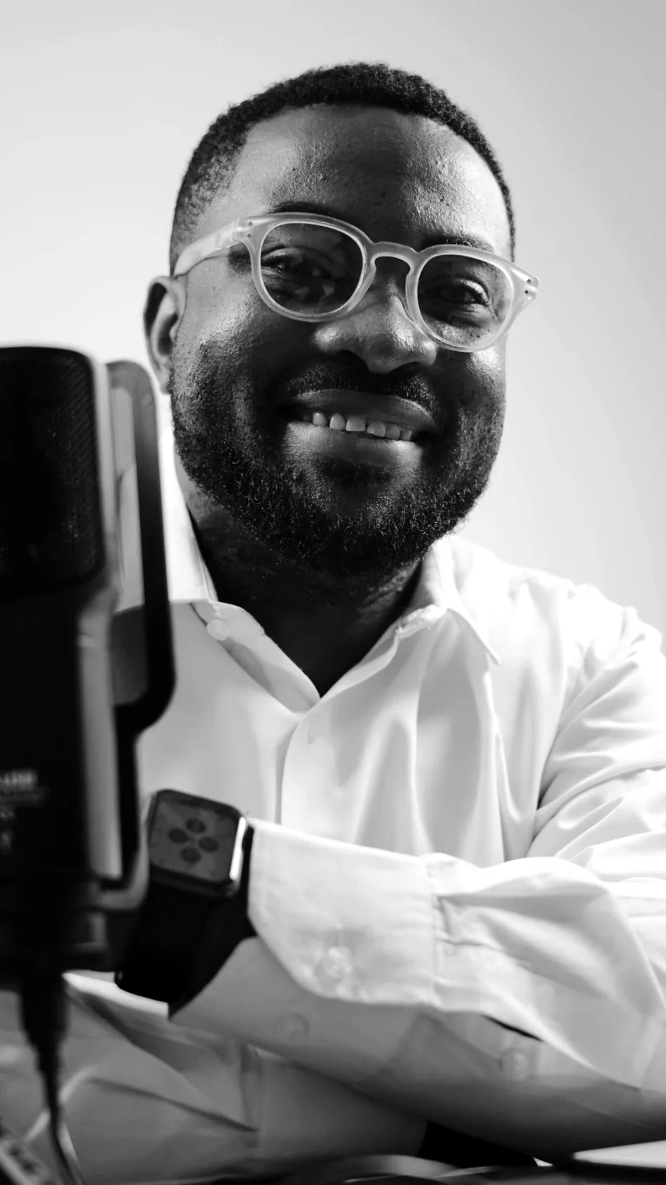 Black and white portrait of an African presenter with a microphone